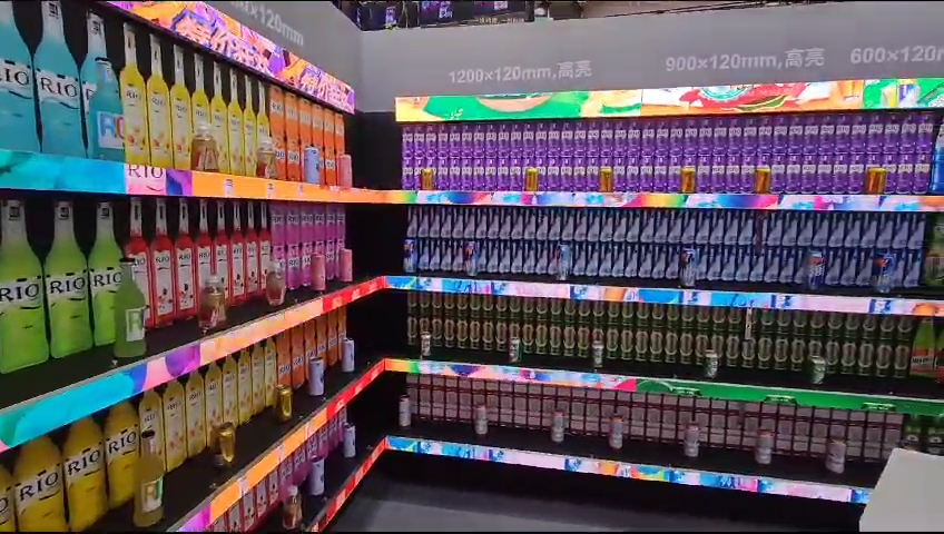 Close-up of LED shelf edge display screen showing promotional pricing content in a South African retail store